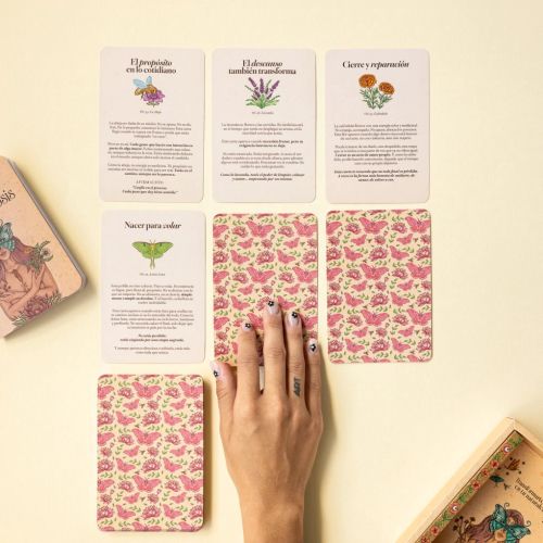 Tarot cards with floral patterns and Spanish text, hand included, by Carolina Zambrano