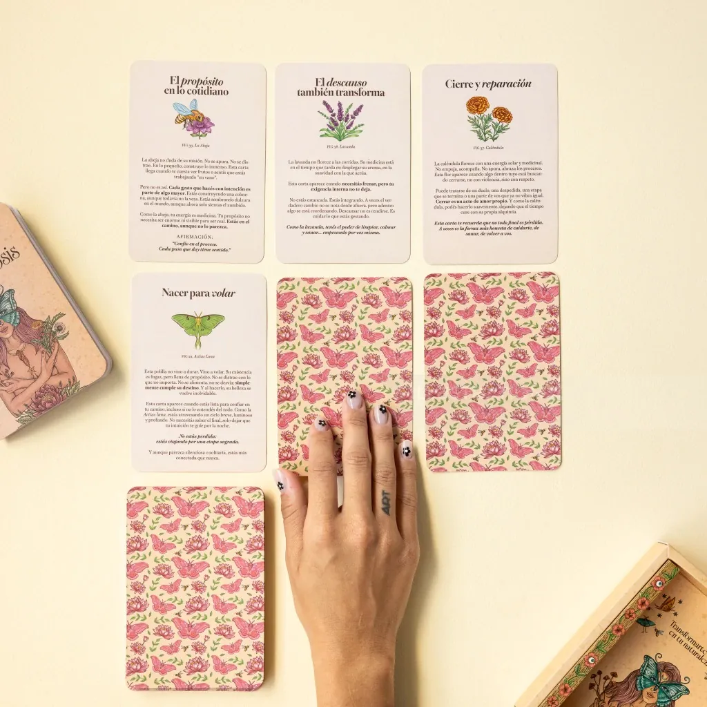 Tarot cards with floral patterns and Spanish text, hand included, by Carolina Zambrano