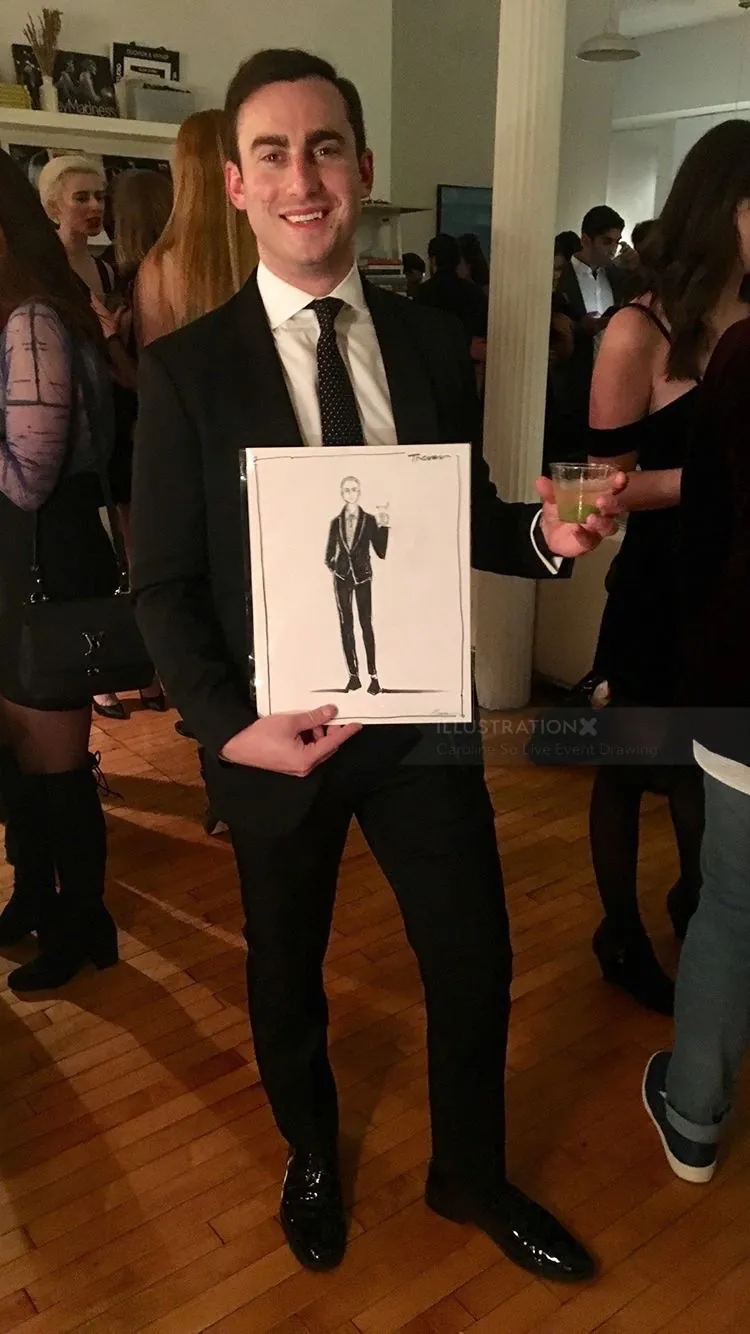 Man in suit holding portrait sketch at event by Caroline So