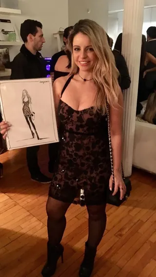 Woman in black dress holding fashion illustration by Caroline So