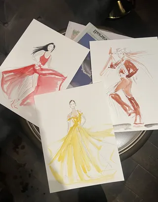 Watercolor fashion sketches of women wearing red, yellow, and brown dresses