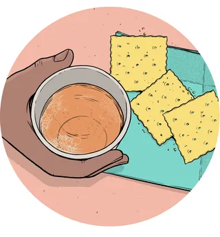 Hand holding a small bowl of sauce near three crackers by Cat Sims
