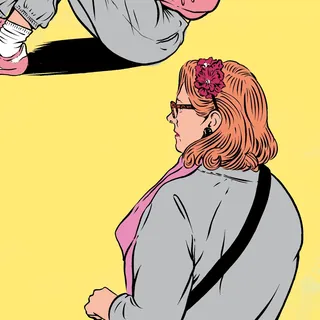 Side view of a woman with glasses and flower accessory in hair