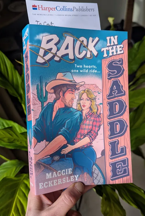 Book cover of Back in the Saddle by Maggie Eckersley, cowboy and woman illustration by Cat Sims