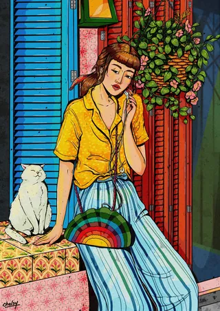 Woman sitting beside a white cat near colorful wall and plants by Chelsy Escalona