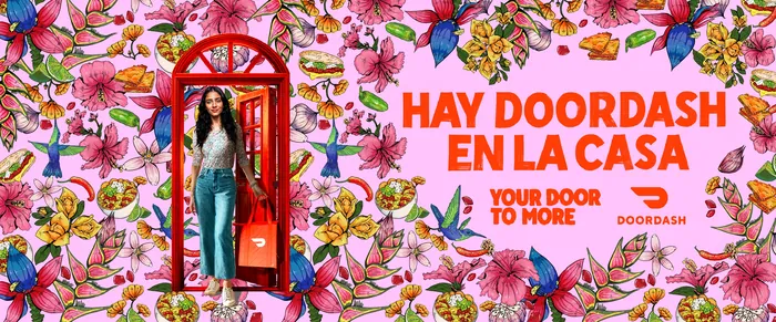 Person standing in red phone booth with floral background and DoorDash ad