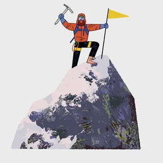 Mountaineer on snowy mountain summit celebrating success