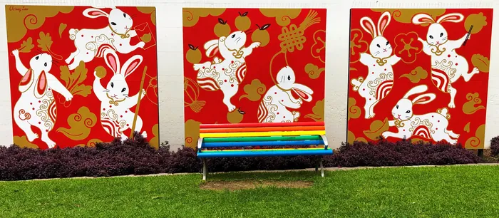 Colorful rabbit mural with red background and decorative patterns