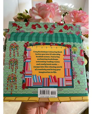 Back cover of cozy bookshop coloring book with flowers and books illustration