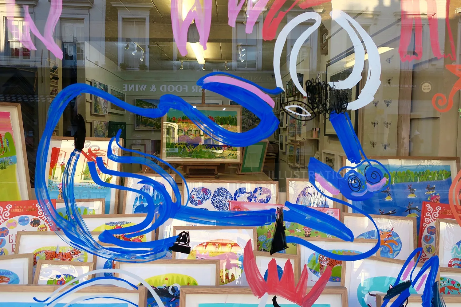 Abstract blue and pink animal painted on a storefront window