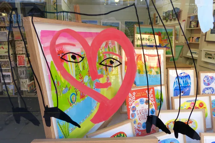 Abstract artwork featuring a pink heart and eyes in a colorful setting