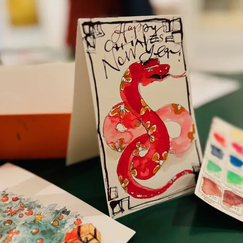 Chinesische Neujahrskarte mit roter Schlange und handgeschriebenem Gruß