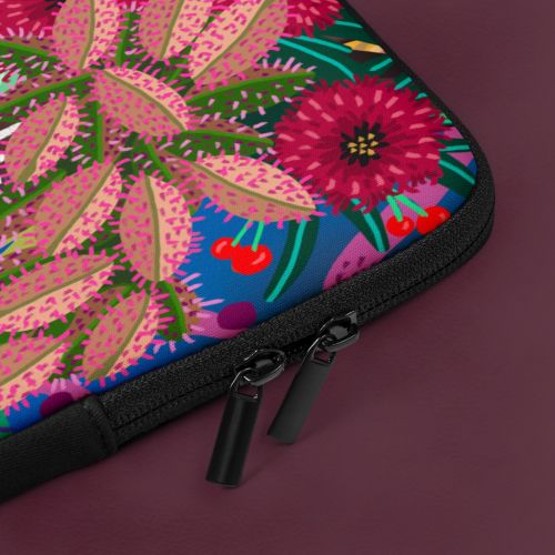Close-up laptop sleeve detail showing zipper and colorful botanical print