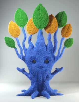 Blue tree plushie with colorful leaves representing children's values