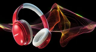 Red Bose headphones emitting colorful sound waves