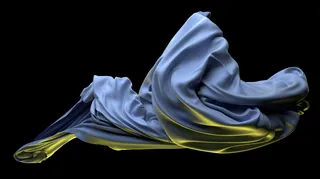 3D rendering of flowing blue fabric with yellow highlights on black background