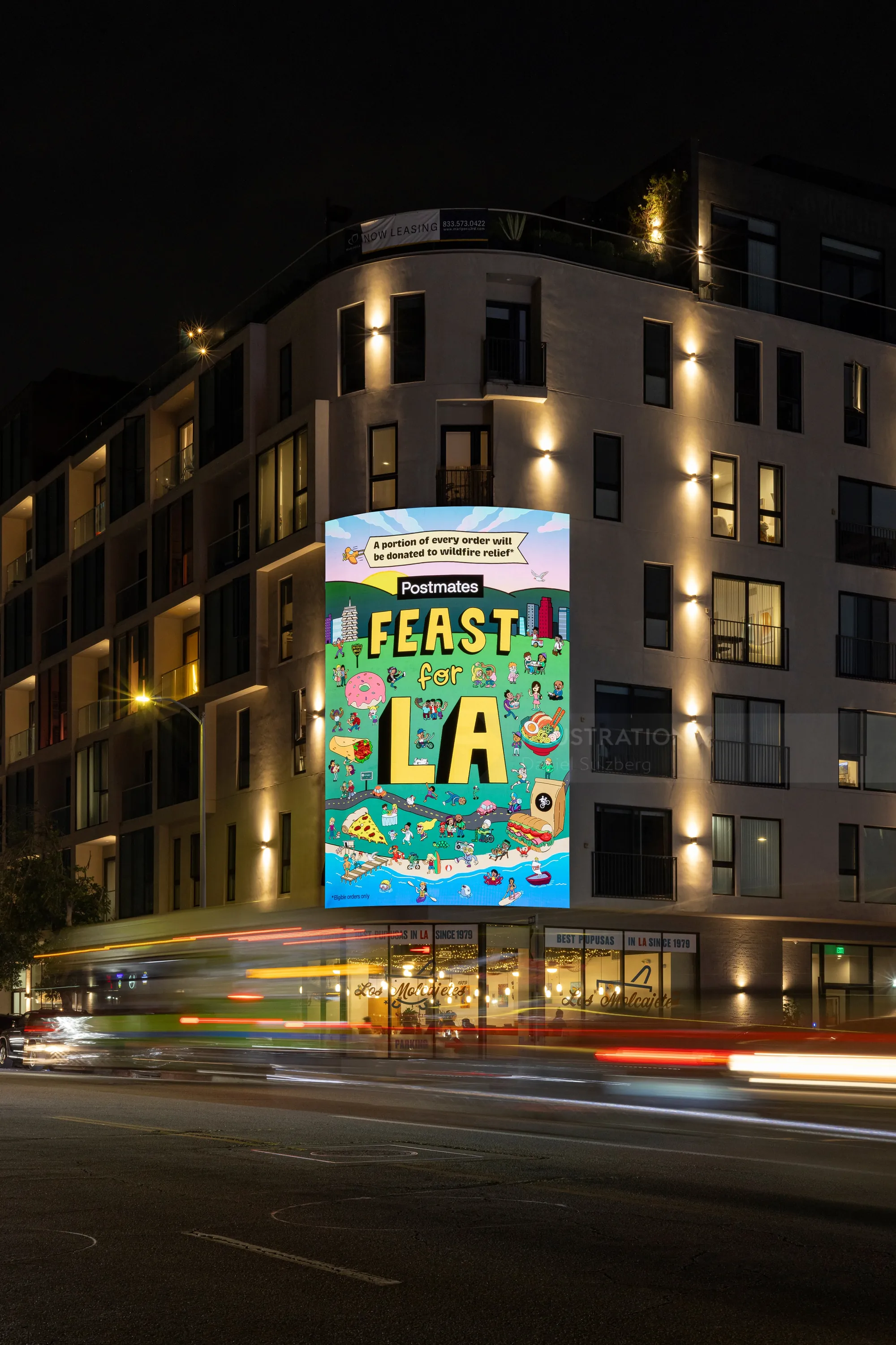 Feast LA banner on city building at night by Daniel Sulzberg
