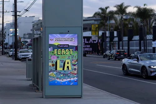 Digital billboard showing Feast LA event poster by Daniel Sulzberg