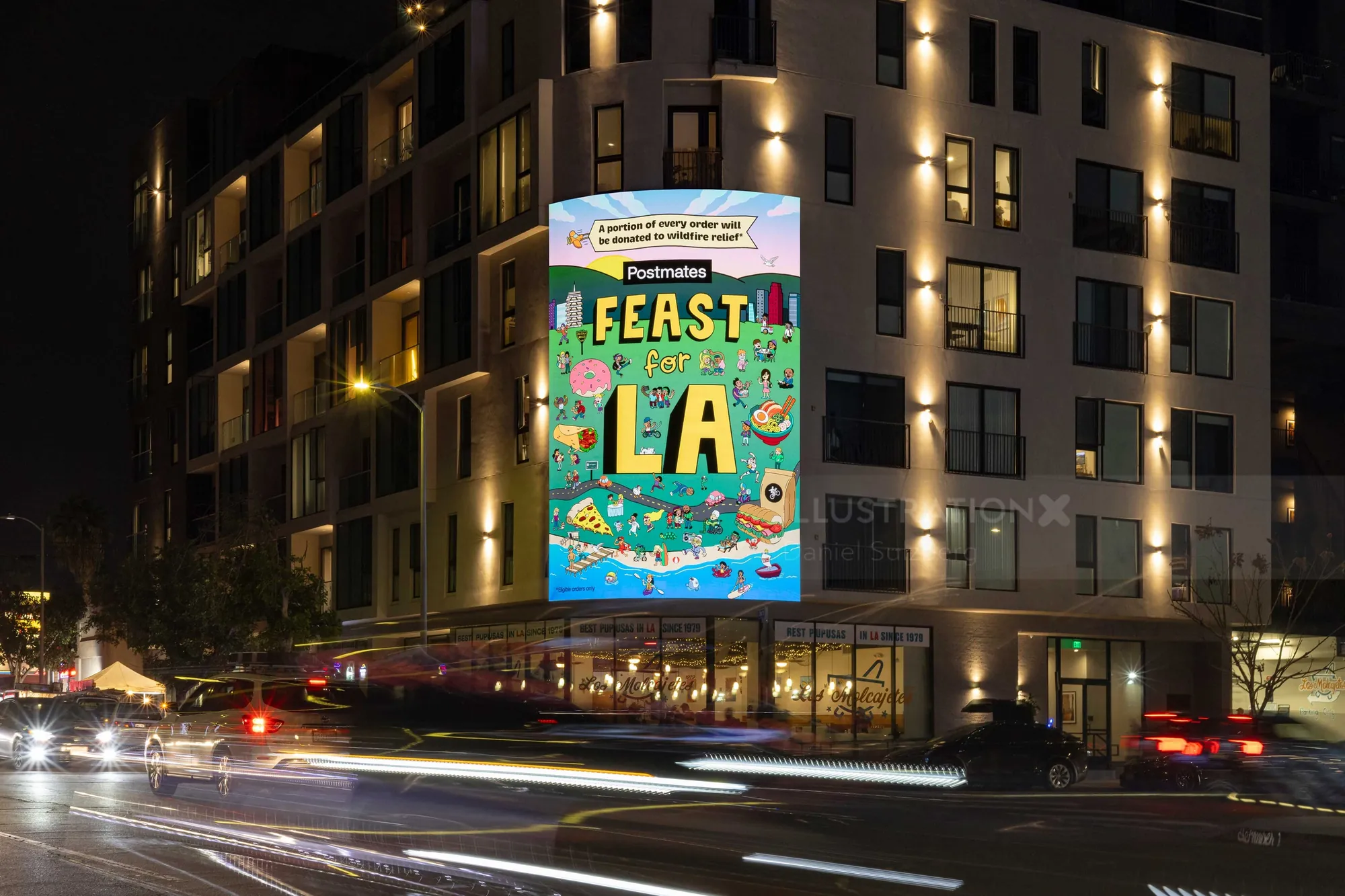 Daniel Sulzberg’s Feast LA poster illuminated on a city building at night