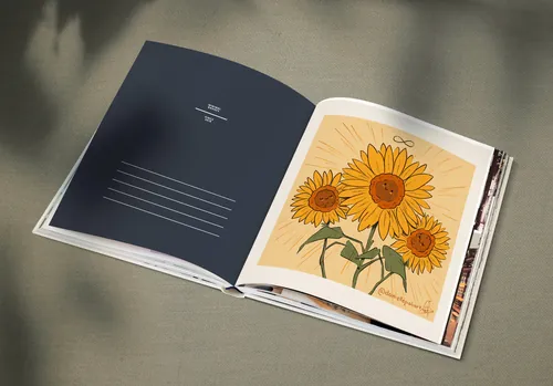 Open book with illustration of three sunflowers on a beige background by Danielle Pioli