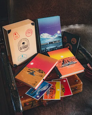 Colorful notebooks and cards on a leather chair by Davi Augusto