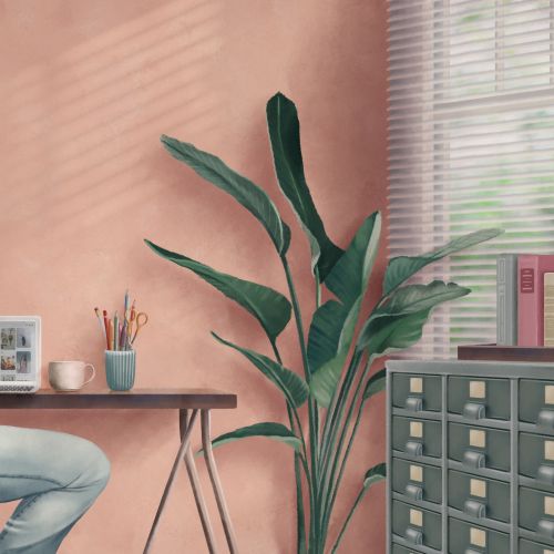 Woman sitting in home office with plants and shelves by Debora Islas