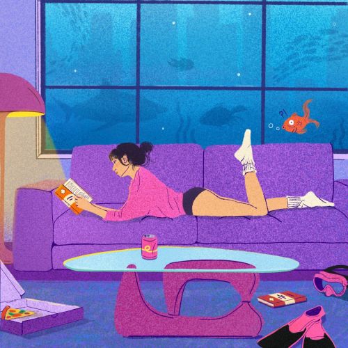 Woman reading on couch with aquarium background by Debs Lim