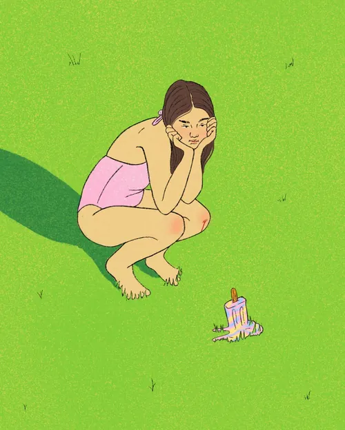 Girl crouching on grass watching melting popsicle by Debs Lim