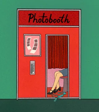 Red photobooth with woman's legs and shoes inside by Debs Lim