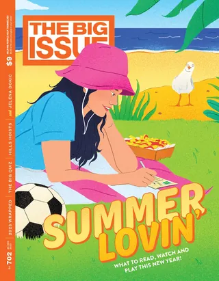 Woman writing on paper at beach with soccer ball and bird nearby
