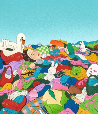 Person resting in a colorful pile of clothes and toys outdoors