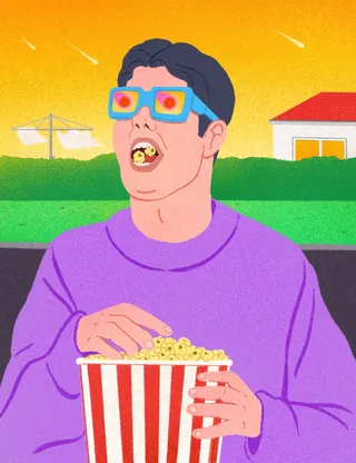 Person with 3D glasses eating popcorn outside during shooting stars
