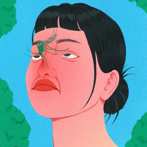 Woman with short dark hair and a spider on her nose looking up.