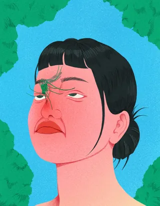 Woman with short dark hair and a spider on her nose looking up.