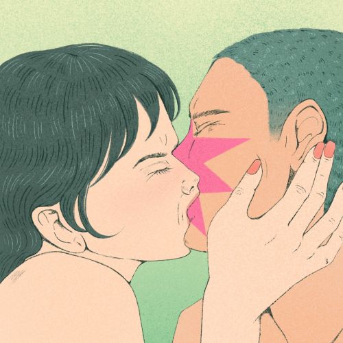 Two people sharing an intimate kiss with colorful face paint.