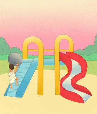 Child happily climbing stairs to a playground slide at sunset