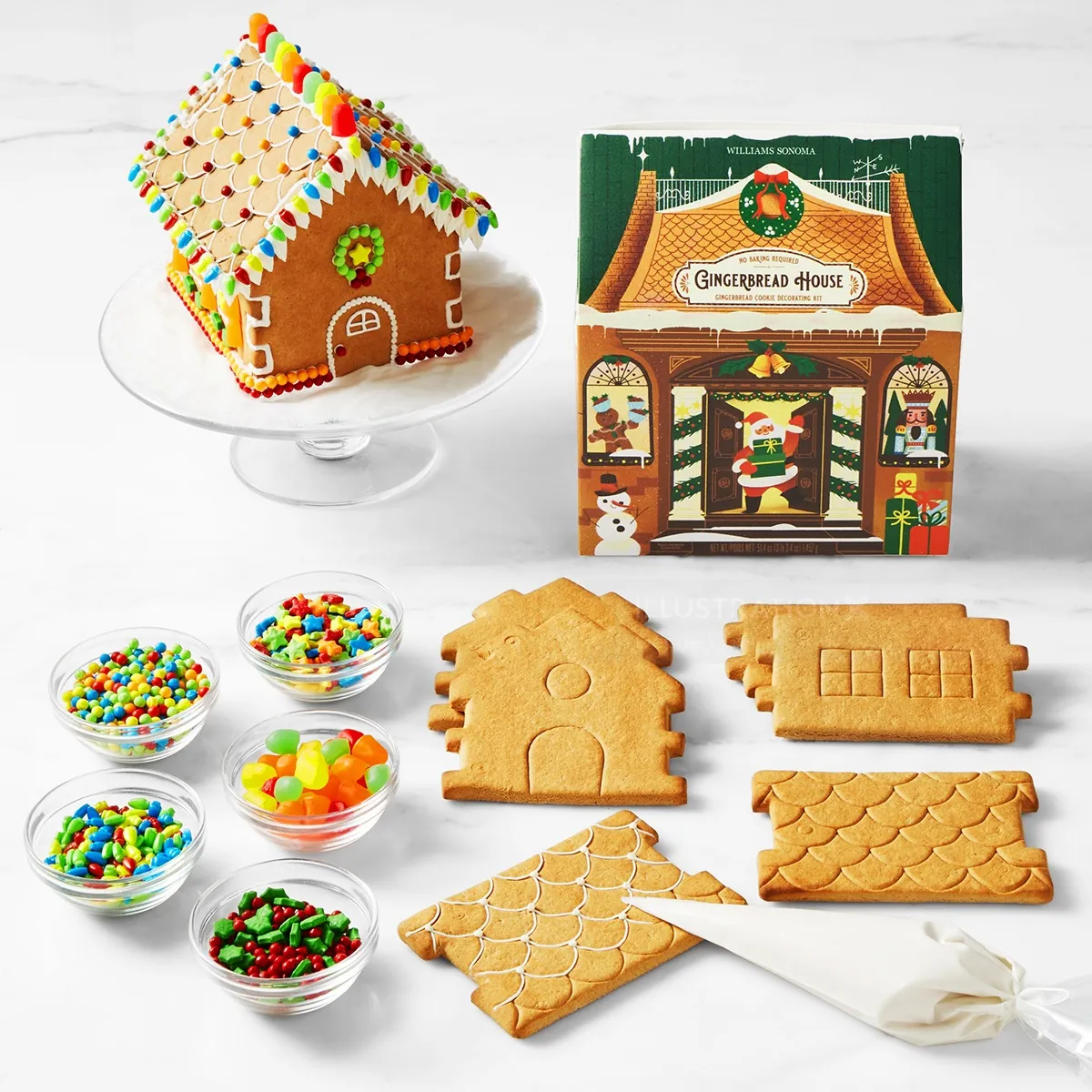 Gingerbread house kit with decorated house and cookie pieces for assembly