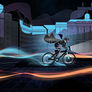 Person cycling at night with glowing neon light trails in a city