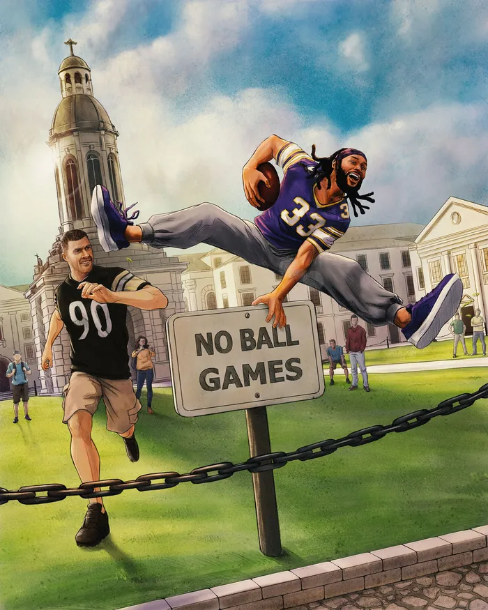 Football player jumps over no ball games sign evading defender