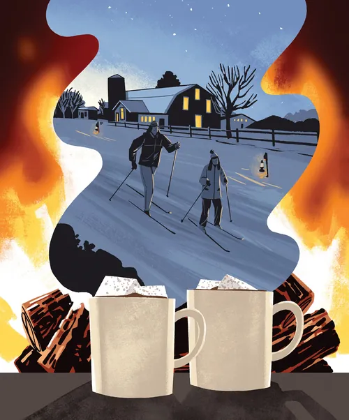 Mother and daughter skiing at night with fire and hot drinks by Drew Bardana