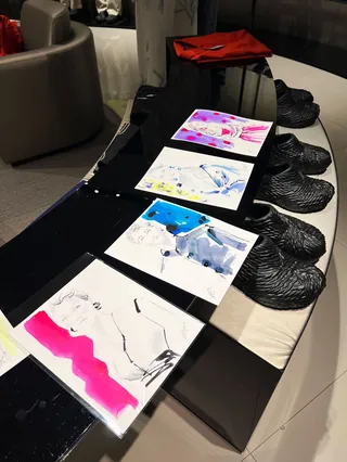 Live event sketches displayed with black Emporio Armani shoes, by Elise Lee