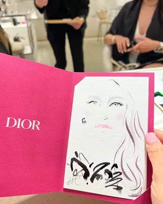 Live event sketch of a woman's face on Dior card by Elise Lee