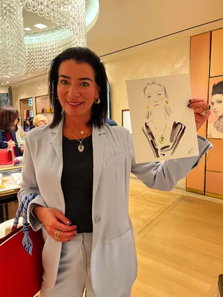 Woman presenting a fashion sketch at Bulgari event by Elise Lee