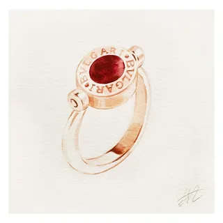 Bulgari ring with red gemstone on white background