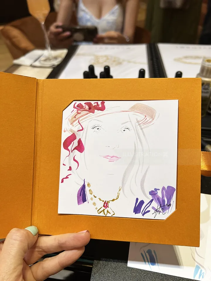 Hand holding a card with a colorful fashion illustration of a woman
