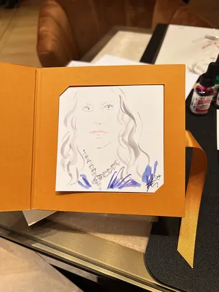 Sketch portrait of a woman with jewelry on a table