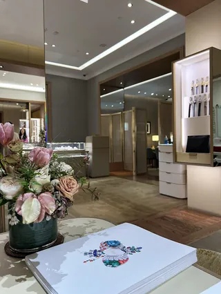Elegant Cartier boutique interior with flower arrangement and jewelry display
