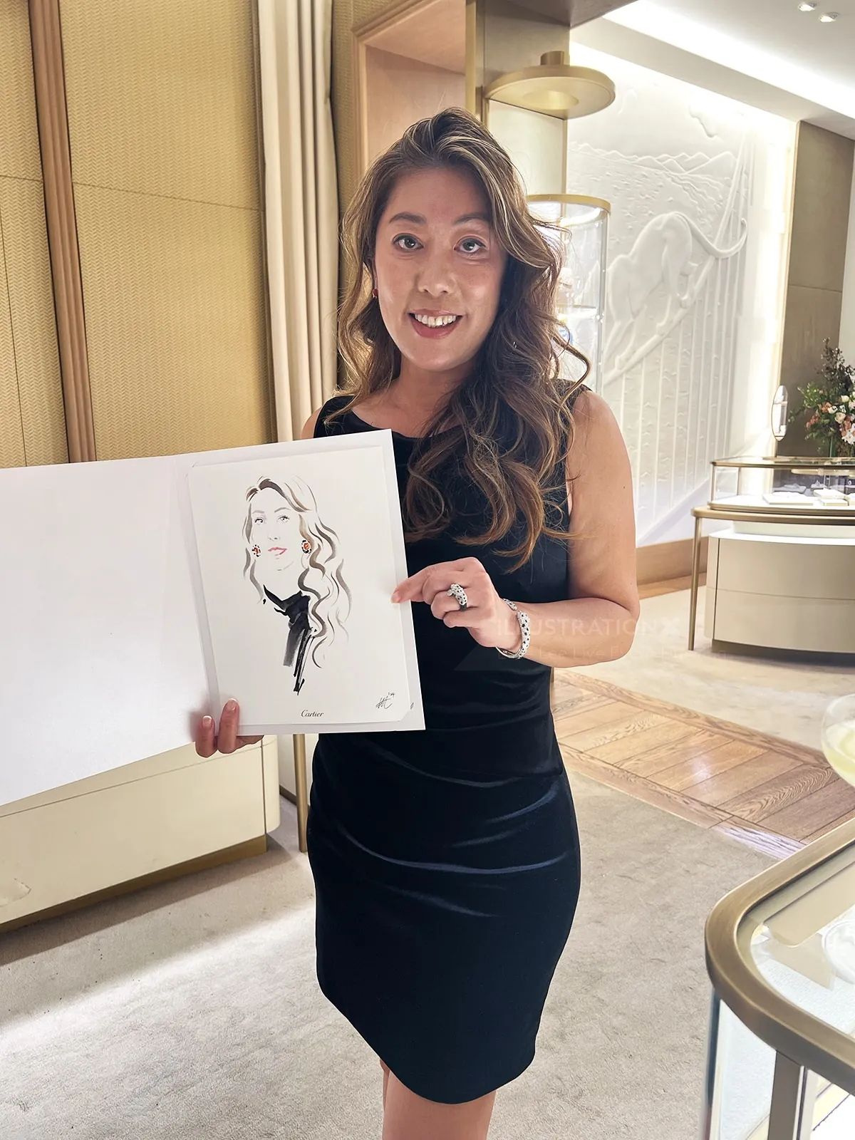 Woman in black dress holding a caricature drawing