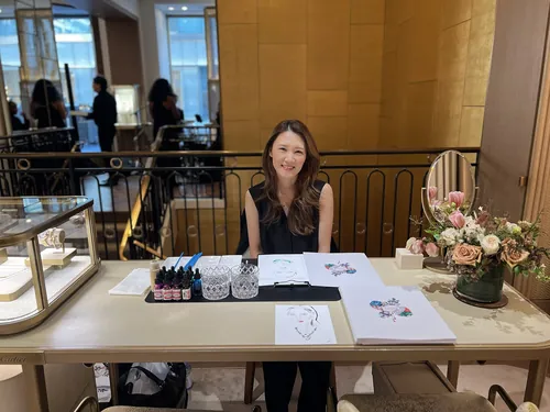 Artist Elise Lee drawing live illustrations at Cartier event