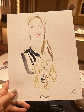 Hand holding a minimalist watercolor portrait of a smiling woman
